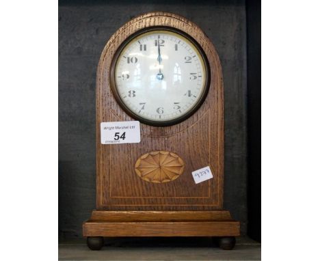 An Edwardian inlaid oak mantel clock.