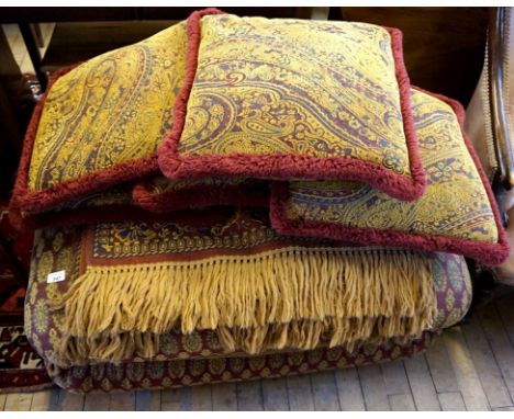 A stylish modern pouffe together with six similar cushions and throw, each upholstered in an Islamic style material.