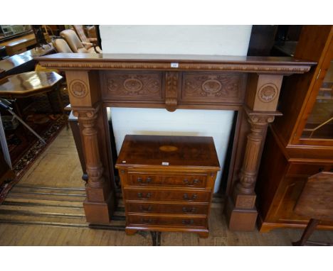 A modern hardwood fire surround having carved floral decoration. CONDITION REPORT: Lot 578
Light scratches to top, scuffing t
