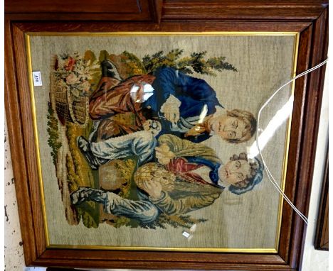 An early 20th Century oak framed tapestry panel depicting two huntsman seated.
