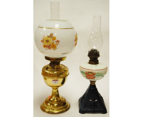 An early 20th century brass pedestal oil lamp having an opalescent globular glass shade together with one other oil lamp (lac