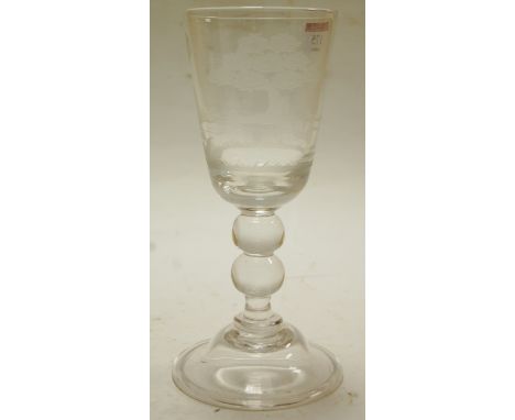 A large early 20th century pedestal goblet engraved with a hunting scene on a double knopped stem and circular base