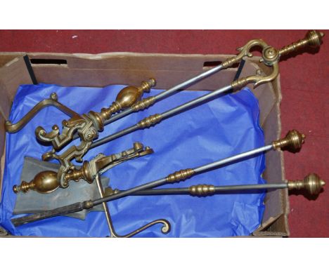 A set of Victorian steel and turned brass fire tools together with a pair of brass andirons