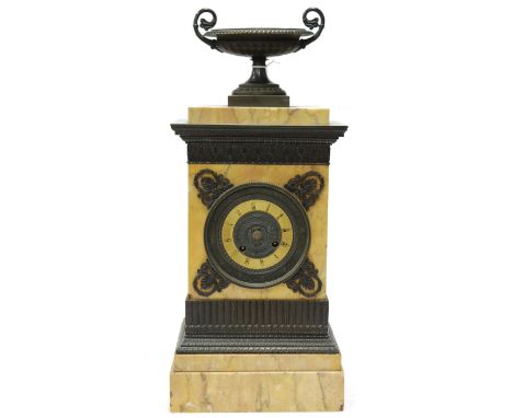 A 19th century French marble mantel clock having a matt chapter ring with Roman numerals with gilt metal spandrels, the whole