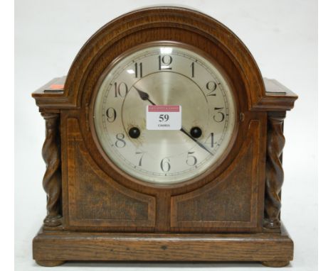 A 1920s oak cased mantel clock, having silvered dial and Arabic numerals 