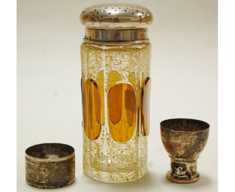 An early 20th century continental amber glass and silver mounted sugar sifter, together with silver napkin ring and silver eg