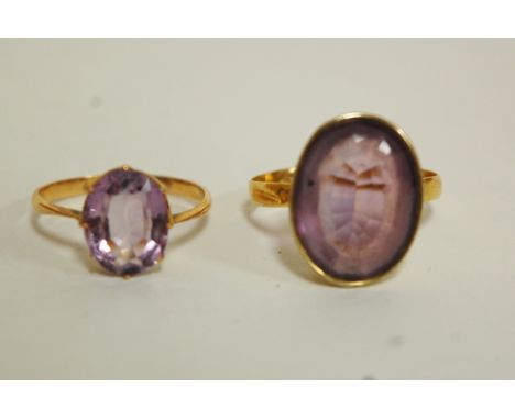 A ladies 22ct gold and amethyst set dress ring; together with an 18ct gold example (2) gross weight 6.2g Condition Report / E