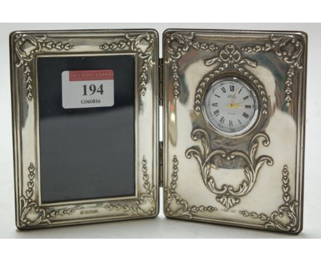 A modern silver mounted photograph frame/mantel clock, with presentation inscription verso