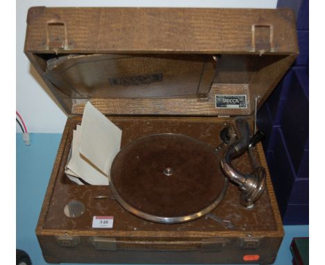 An early 20th century Decca wind-up portable gramophone, and records