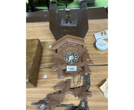 A VINTAGE WEST GERMANY BLACK FORREST CUCKOO CLOCK TOGETHER WITH A TREEN MONEY BOX