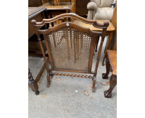 AN EARLY 20TH CENTURY OAK AND CANE FIREGUARD WITH BARLEY TWIST STRETCHER