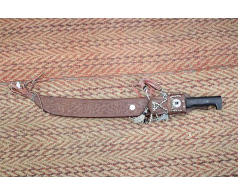 A LONG BRAZILIAN MACHETE IN AN ORNATE LEATHER SHEATH