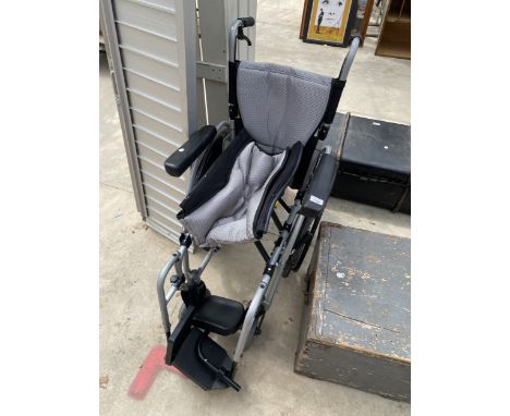 A KARMA SELF PROPPELLED AND PUSH ALONG WHEELCHAIR