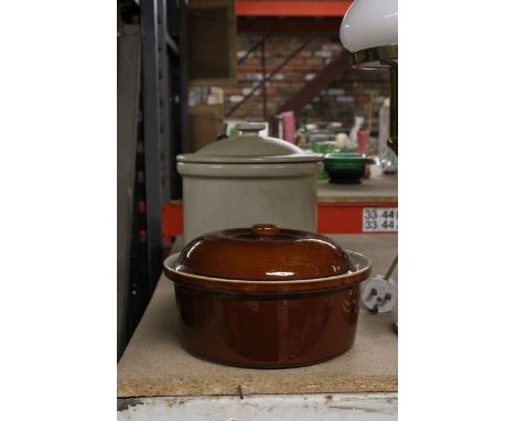 A LARGE HEAVY STONEWARE LIDDED BREAD BIN ALONG WITH A TREACLE GLAZE LIDDED STONEWARE OVEN DISH