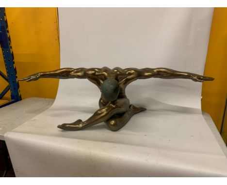 A LARGE BRONZE COLOURED RESIN SCULPTURE OF A NUDE MALE WITH ARMS OUTSTRETCHED IN A YOGA POSE - 135 CM (W) 44 cm (H)