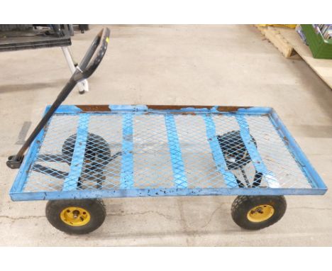 Industrial 4 wheeled platform truck with heavy duty mesh platform and steerable front wheels. Platform measures 122cm long, 6