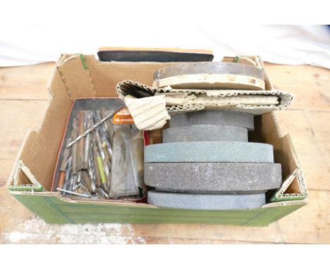 Box of various sized grinding wheels and tin of drill bits.