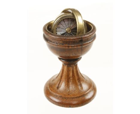 A ships compass with floating brass holder in 3 1/2" turned oak stand G+