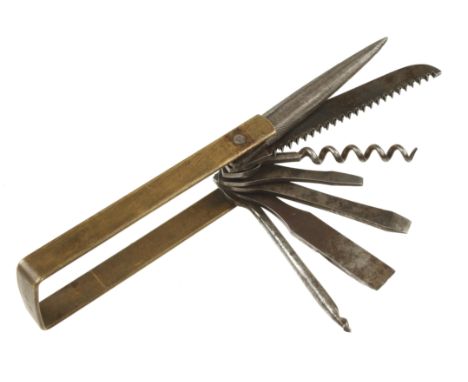 An early French cavalryman's 7 tool folding pocket compendium inc. file, saw, corkscrew etc in brass surround G+