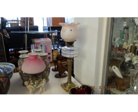 A brass Corinthian  column oil lamp with cut glass font and Tulip shade and chimney