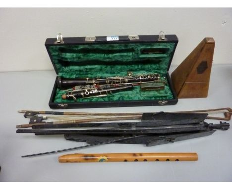 F. Buisson clarinet (cased), metal music stand, metronome, two violin bows and a wooden recorder 