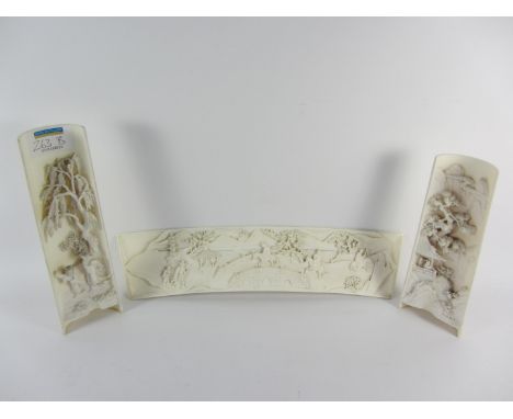 Two 19th/20th century carved Chinese half section ivory tusk ornaments, each with deep carved decoration depicting figures in