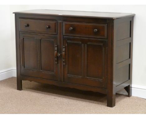 Ercol medium elm sideboard fitted with two drawers and two cupboards, W131cm, H89cm, D49cm