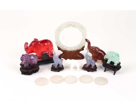 A Chinese Jade amulet, carved and pierced with two opposing dragons, 8.7cm x 8cm, in wood stand, a Chinese amethyst coloured 