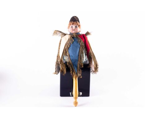 A 19th German musical marotte doll, with bisque head on a turned wooden handle, 34 cm high