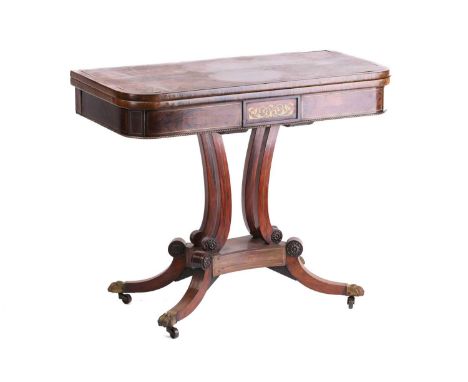 A Regency figured rosewood brass inlaid rectangular fold-over card table, with stylized fleur de Lis inset top on an open ped