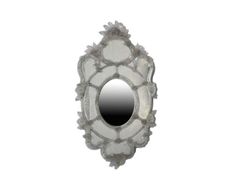 A Venetian cartouch form wall mirror, late 19th century, decorated with etched detail and drawn glass flowers, leaves and gla