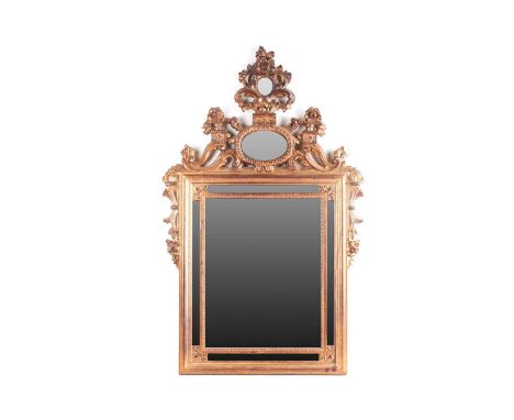 A Florentine style carved and giltwood wall mirror, 20th century with a Neo-Classical frame, set with six smaller mirrors. 54