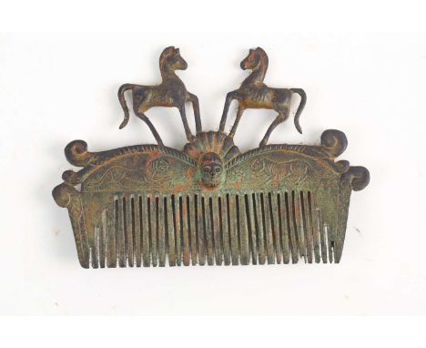 A Roman-style verdigris bronze hair comb with twin prancing (Bucephalus? )horses mask and scroll decoration. 14 cm wide x 10 