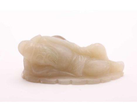 A Chinese jade figure of Lu Dongbin, carved sleeping against a double gourd, 6.5cm
