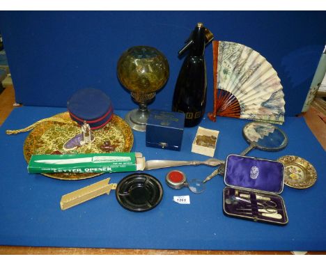 A quantity of miscellanea to include; an oil lamp with amber glass shade, hand mirror, manicure set, letter opener, shoe horn