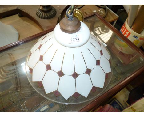 A conical glass lamp shade in geometric design, white, mauve and gilt.