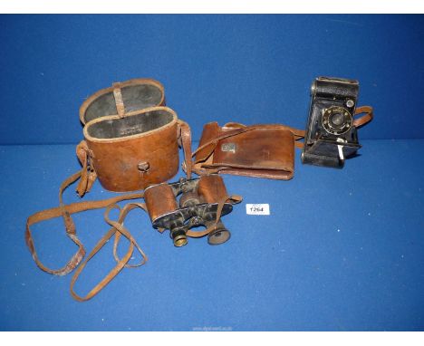 A leather cased pair of R.J. Binoculars, (one eye piece missing) and a cased Kodak camera.