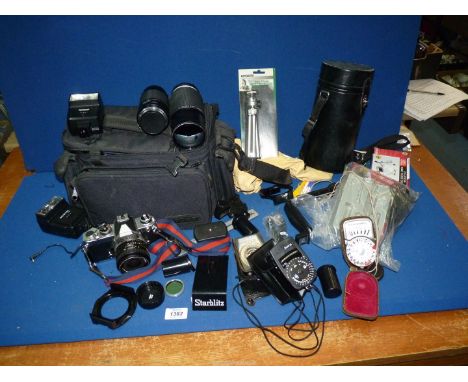 A Nikon 35mm SLR Camera Outfit including a Nikon FM Body, No. 2157178, a Nikon Series E 35mm f/2.5 Lens, No. 1823286 a Nikon 