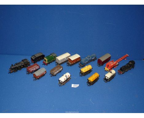 A small box of 'OO' trains/trucks including; United Dairies tanker, LMS engine and tender, etc.