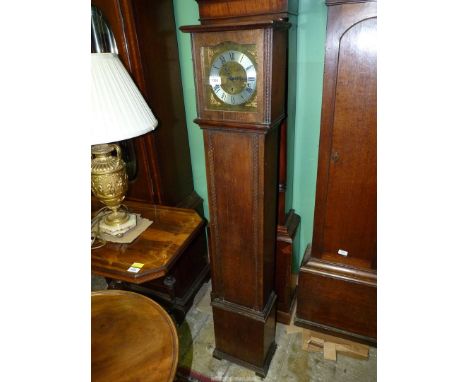 An Oak grandmother's Clock having a three train movement with Roman numerals, 10 1/2'' wide x 7 3/4'' deep x 55 3/4'' high, s