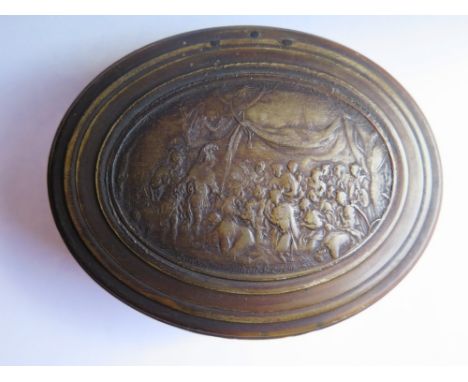 An Eighteenth Century Oval Snuff Box made from pressed horn and decorated with a vignette of Alexander The Great standing bef