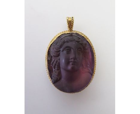 A Victorian Carved Amethyst Cameo Pendant decorated with bust of lady in a gold setting with inscription 'To Grandma J.J.R. 1