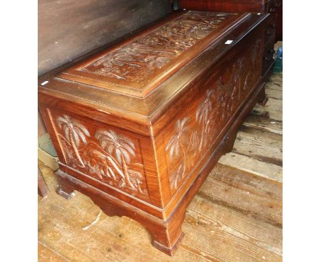 Large Indian rosewood chest with carved elephants and palm trees panel on the lid, with a fitted inner rosewood tray, standin