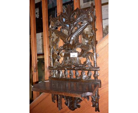 Black Forest oak wall shelf, with finely carved game bird on a panel above. Approx 49cm high