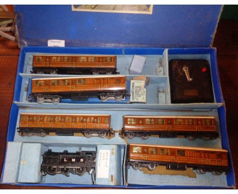Part boxed set (pre war) including 5 brown suburban coaches (1 boxed) transformer, and a 0-6-2 tank engine (not working), the