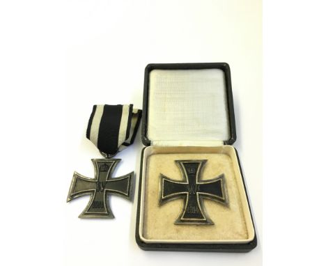 A pair of WWI German Iron Cross First and Second Class medals (one in original presentation box).