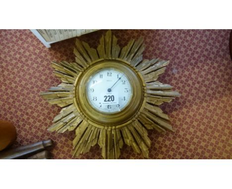 A small three day French gilt wood Sunburst wall clock.