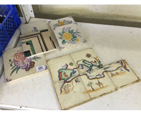 Three various early 20th century Poole Pottery tiles decorated in traditional floral bouquet patterns together with an Art De