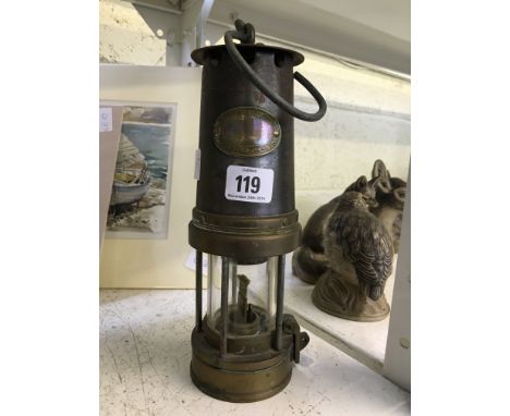An early 20th century Patterson brass and metal miner's lamp.