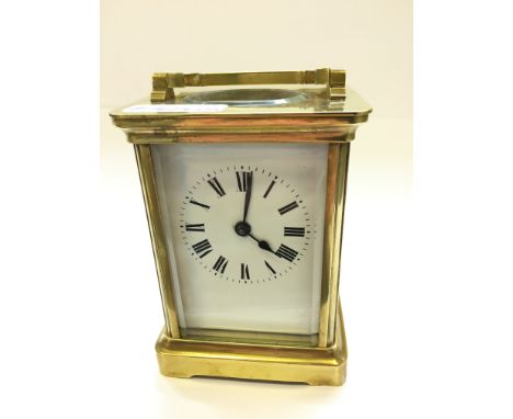 A brass and glass cased carriage clock (minor faults to dial).